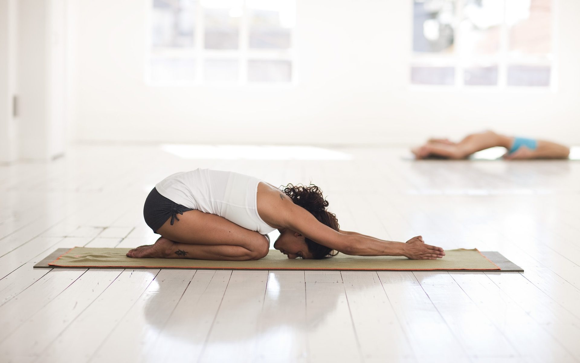 female in childs pose yoga in meditation